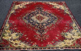 AN OLD PERSIAN TABRIZ RUG in traditional floral design, 270 x 185 cms