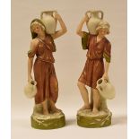 A PAIR OF ROYAL DUX FIGURE WATER CARRIERS on circular naturalistic bases, 25cms high