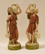 A PAIR OF ROYAL DUX FIGURE WATER CARRIERS on circular naturalistic bases, 25cms high