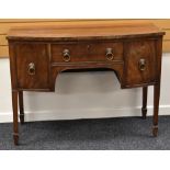 A REGENCY-STYLE MAHOGANY BOW FRONTED SIDE BOARD on raised legs with two drawers either side of a