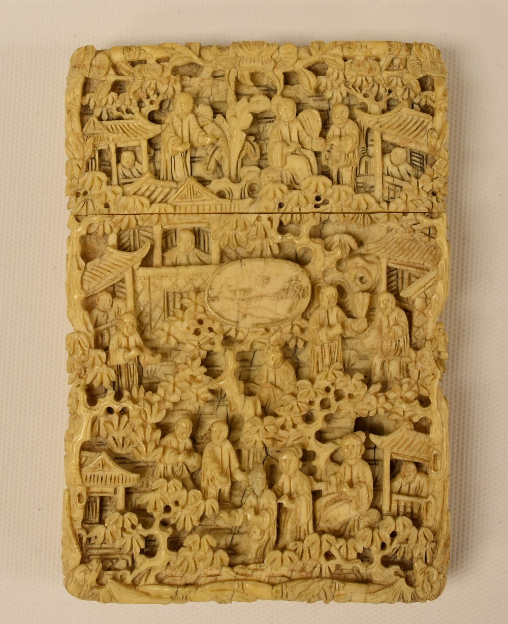 A CHINESE CARVED CARD-CASE having a pull lid and intricately carved all-round with figures and