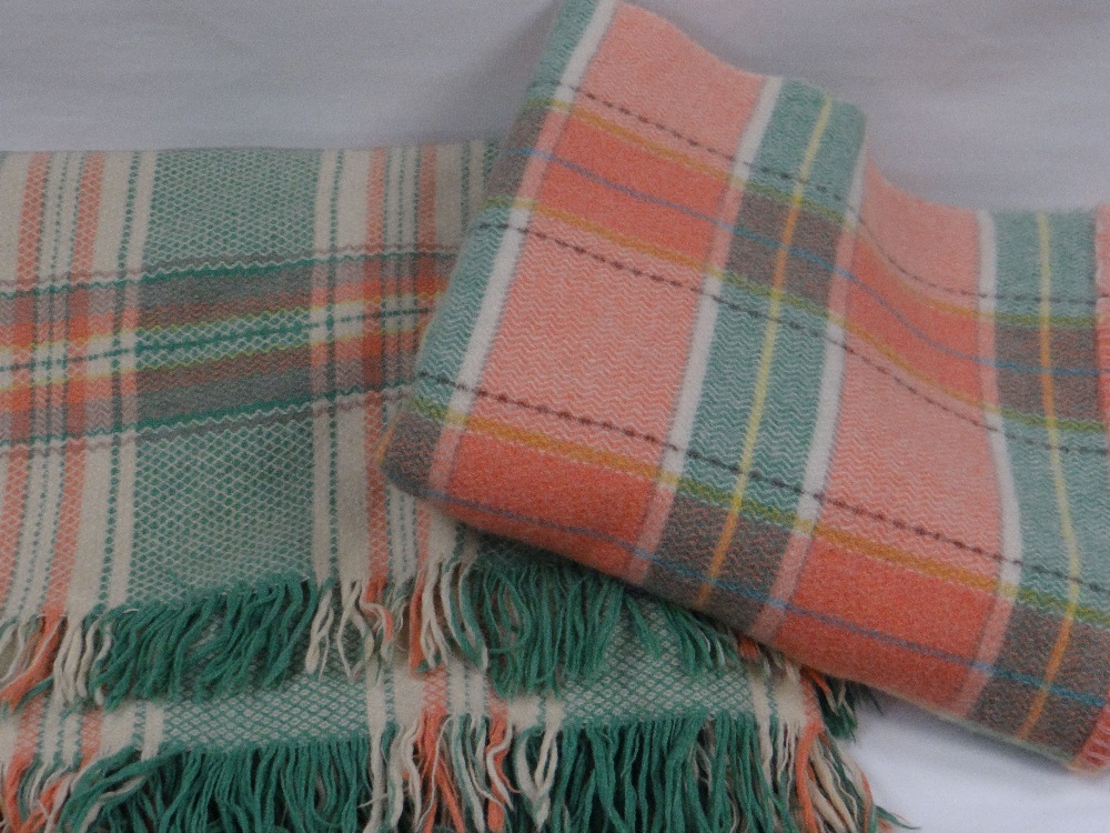 TWO WELSH WOVEN PURE WOOL BLANKETS in pink and green chequer, one bearing 'Real Welsh' label, mid to