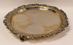 CIRCULAR SILVER FOOTED TRAY with decorative scrolling border and with three scroll feet, Walker &