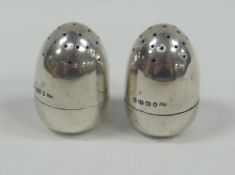 A PAIR OF MINIATURE SILVER PEPPERETTES, egg-shaped and of plain-form, Birmingham 1890 BBC Bargain