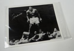 AN AUTOGRAPHED MUHAMMAD ALI BLACK AND WHITE BOXING PHOTOGRAPH