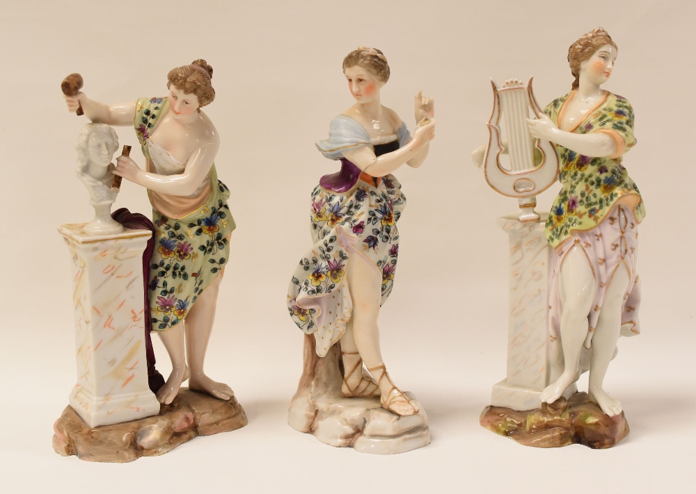 A TRIO OF CONTINENTAL PORCELAIN CLASSICAL FIGURINES, being a standing lyre-player, a sculptor and