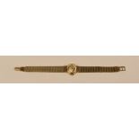 A LADIES 9ct YELLOW GOLD OMEGA WRISTWATCH, the circular dial with hour batons and integral flat