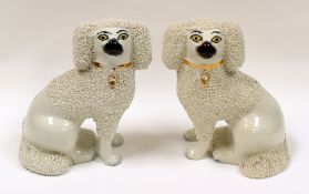 A PAIR OF NINETEENTH CENTURY STAFFORDSHIRE DOGS decorated with shredded clay detail and with painted