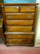 A reproduction mahogany chest on chest, the top section with two short over three long drawers