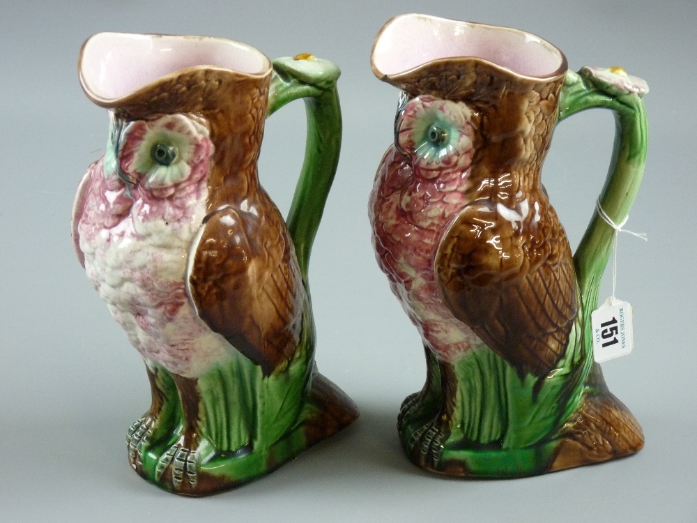 A pair of Majolica pottery owl jugs, 25 cms high (chip to base of one, 12mm chip with hairline crack