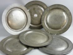 Six 34 cms diameter antique pewter plates, four with fold under rims marked 'Brown' with further