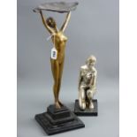 An Art Deco style gilt metal figure of a nude female holding a leaf shaped bowl aloft on a stepped