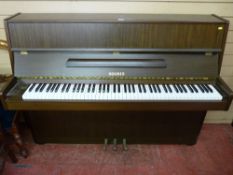 A modern Hohner upright overstrung modern piano, well maintained and of good appearance