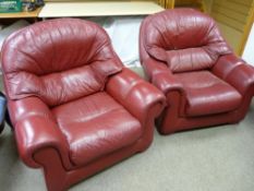 A pair of red leather effect armchairs, 90 x 95 cms