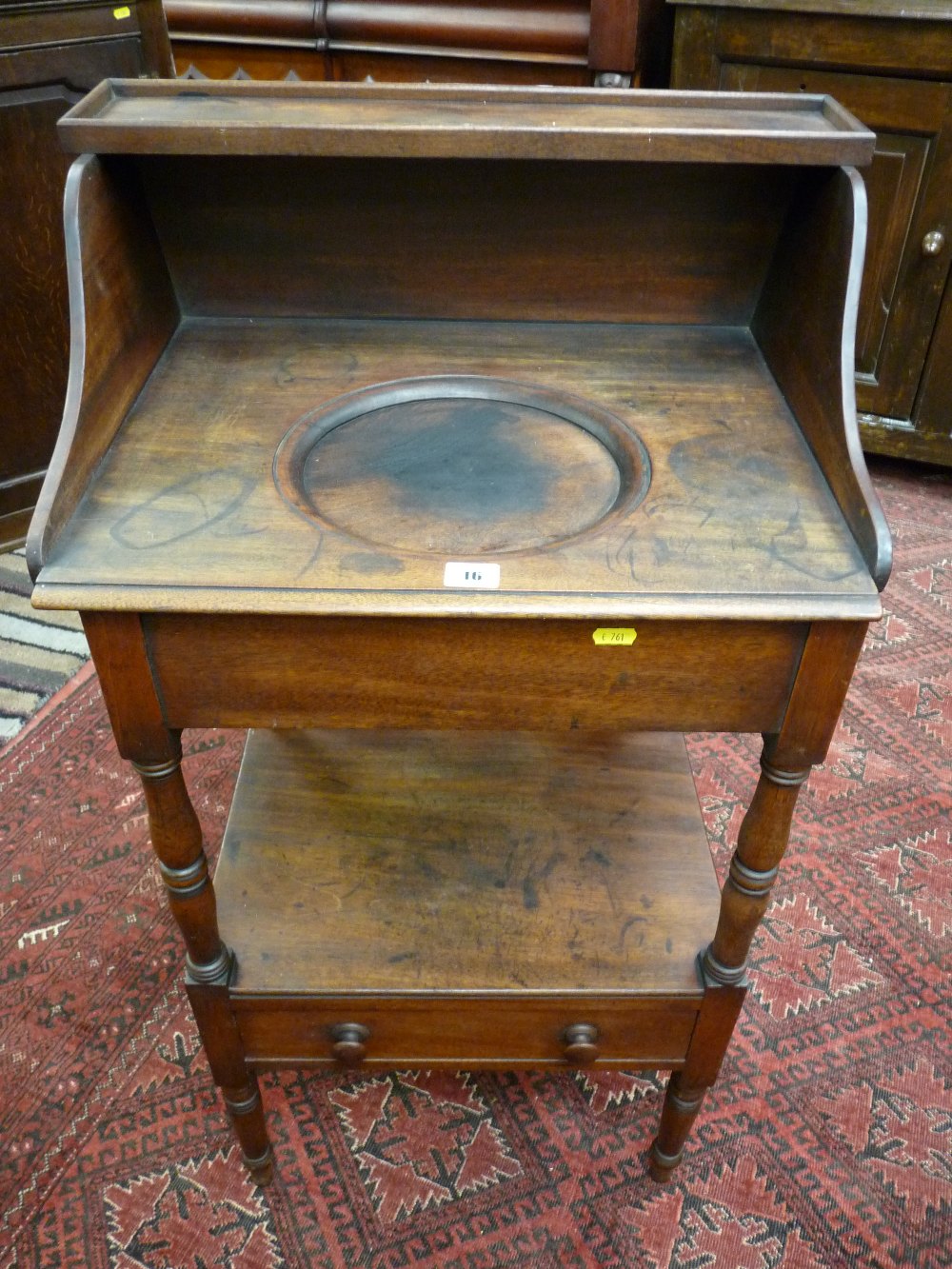 A Victorian mahogany two tier washstand with shaped splashback and top shelf, single lower drawer