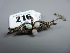 A silver bar brooch encrusted with tiny diamonds and having three central oval white opals, each