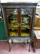 A quality carved mahogany Chippendale style display cabinet with carved swag decoration, blind