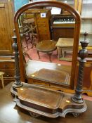 A late Victorian mahogany swing toilet mirror on turned supports and shaped base with lidded