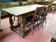 An excellent reproduction oak refectory table, the three plank top over a leaf and berry carved