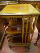 An Edwardian mahogany revolving bookcase, 51.5 cms square top with edge crossbanding and string