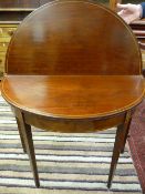 A Georgian inlaid mahogany half moon tea table on square tapering supports with floral inlaid oval