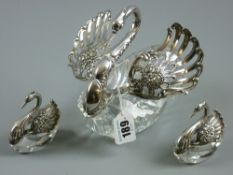 A set of three cut crystal glass and sterling silver swans with articulated wings, the largest 16