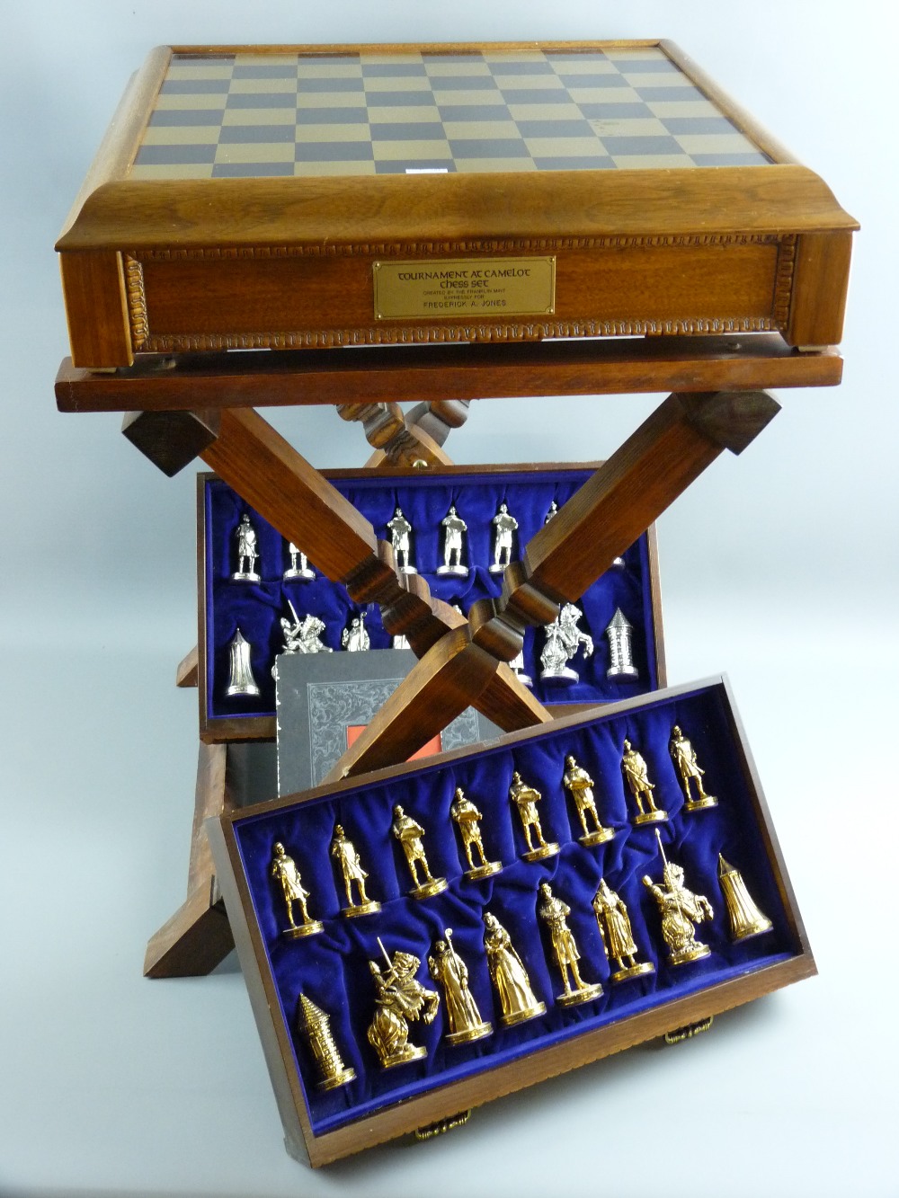 A 'Tournament at Camelot' chess set, circa 1970s, walnut effect chess table on a folding stand,