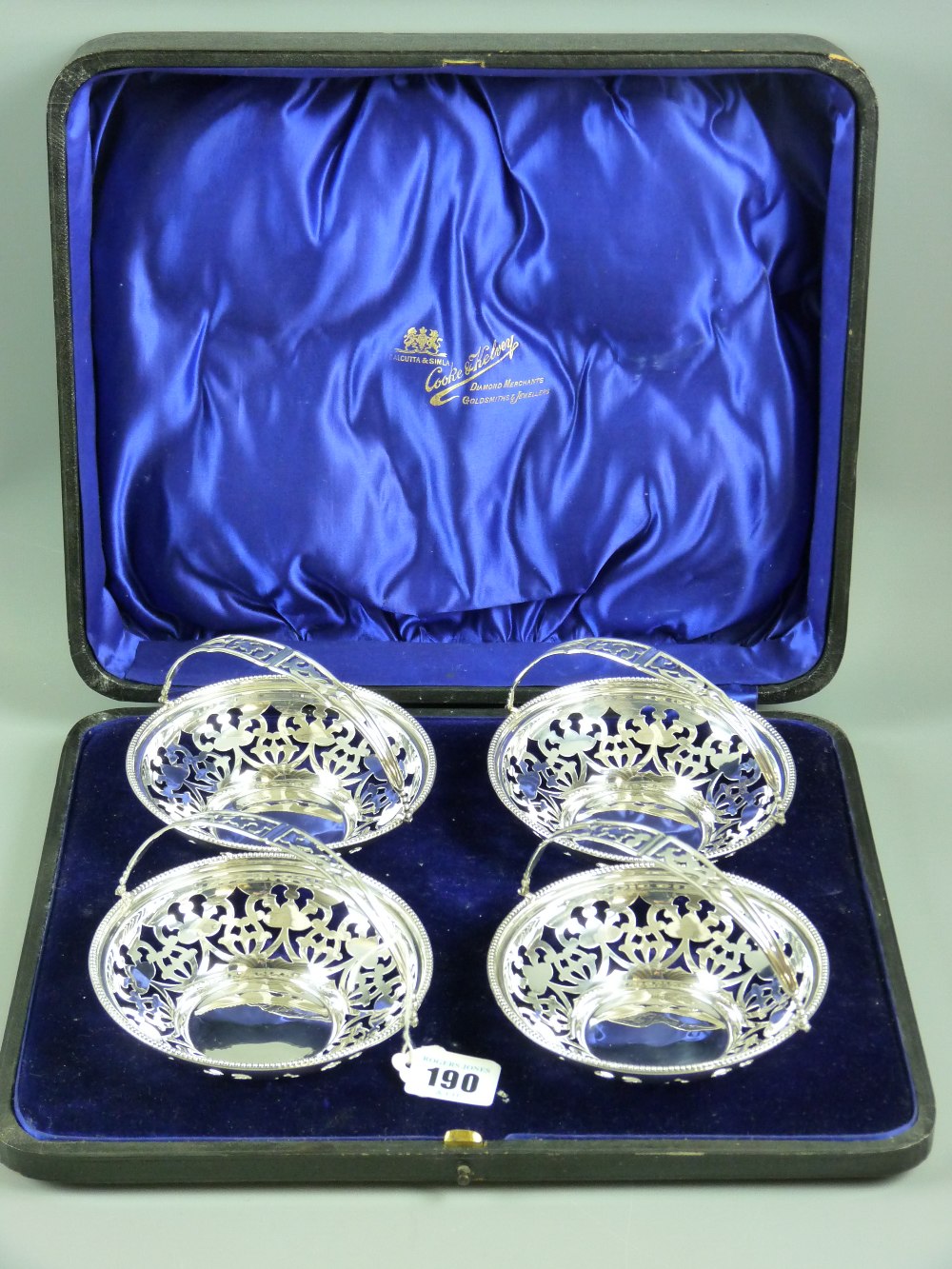 Silver swing handled bon bon dishes, a set of four with pierced bowls and handles with beaded rim