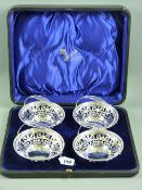 Silver swing handled bon bon dishes, a set of four with pierced bowls and handles with beaded rim