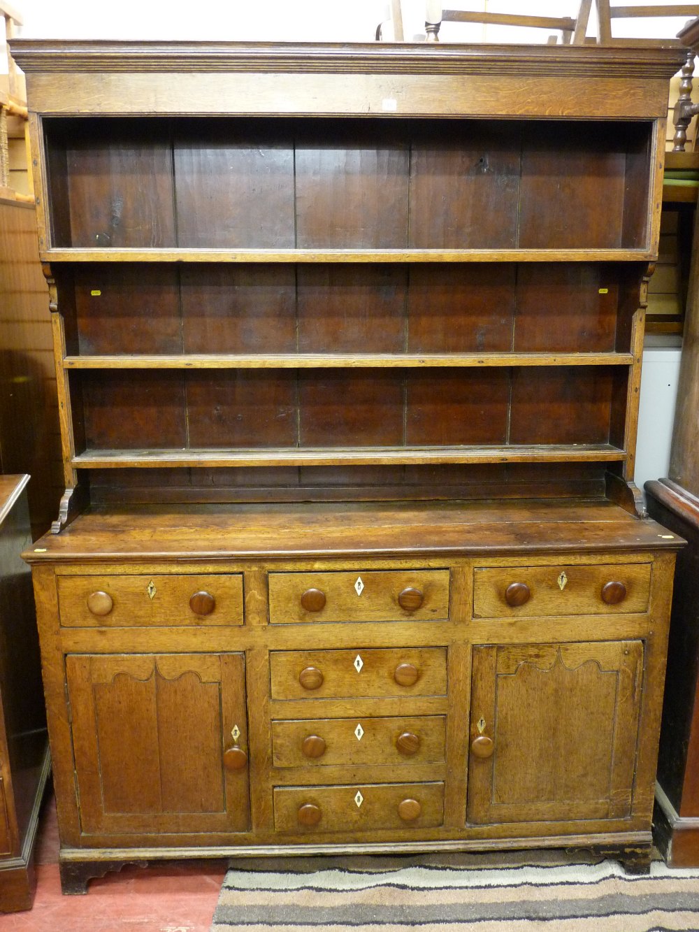 A neat mid 19th Century oak South Caernarfonshire Welsh dresser having a three shelf rack over a