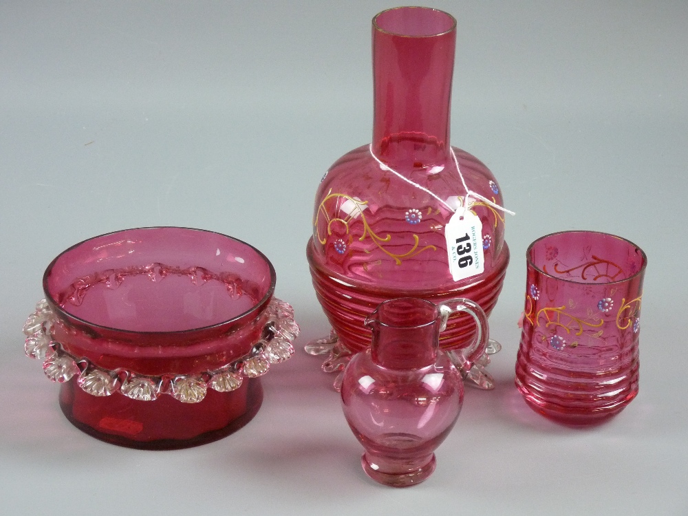 Four pieces of cranberry glass to include an enamel painted rib patterned carafe and beaker, a small