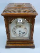 An early 20th Century oak cased bracket clock, the pendulum driven movement striking on gongs with