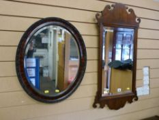 A Georgian style reproduction mahogany wall mirror, 92 x 48 cms and an Edwardian oval wall mirror