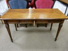 An antique style walnut library table with single frieze drawer on tapering corner supports with