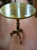 A Victorian carved yew circular topped tripod table, the 47 cms diameter top on a turned and