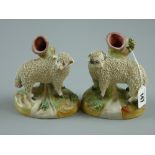 A pair of late 19th Century Staffordshire pottery spillholders modelled as a sheep and a ram