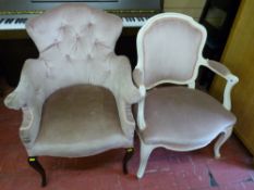 A pink button upholstered French style salon chair with shaped arms on mahogany supports and a white