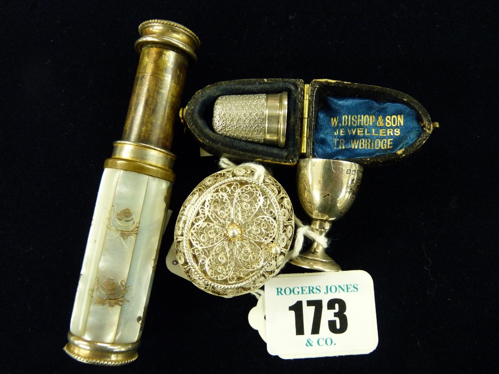 A cased silver thimble, 2.9 grms, a miniature silver trophy cup, 4.2 grms, Birmingham 1925, an