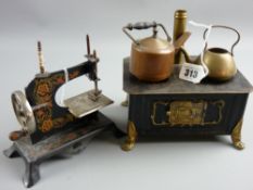 A tinplate cooking stove with brass chimney and brass and copper kettles, 19 cms wide and a German