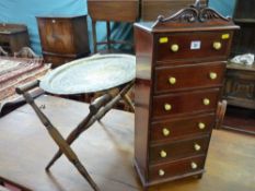 A neat reproduction mahogany six drawer chest with white painted knobs, carved top rail decoration