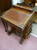 A late Victorian mahogany Davenport with lidded top section having interior stationery compartments,