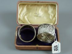 A pair of cased silver napkin rings each with raised floral and leaf decoration, 1.7 troy ozs,