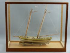 A 20th Century glass cased model of a boat with interior brass plate marked 'Virginia Pilot, Circa