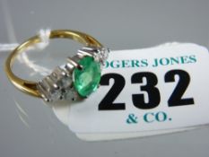 An eighteen carat gold dress ring having a centre oval emerald, approximately 0.8 x 0.6 cms with six