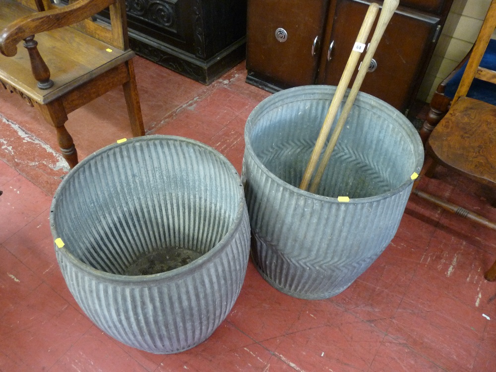 Two galvanized metal wash tubs, 46.5 cms diameter the largest along with two turned wooden push