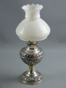 A vintage oil lamp and shade marked 'The New Rochester Junior', the silver plated base with raised