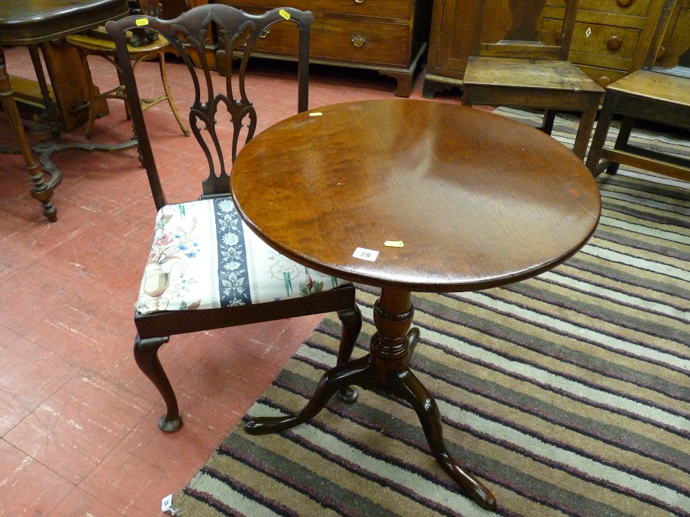 An antique mahogany circular tilt top tripod table with a 61 cms diameter top and a mahogany antique