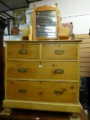 A circa 1900 stripped pine mirrored dressing chest of two short over two short long drawers on bun