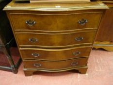 A reproduction walnut serpentine fronted chest of four drawers on corner bracket feet, 83 x 73 cms