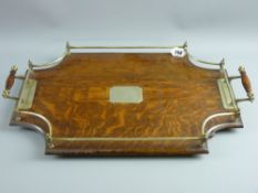 A shaped oak two handled serving tray with plated gallery and mounts, 60 cms long approximately